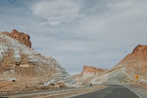 highway through red rock cliffs 