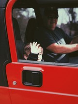 grandpa and grandson in a Jeep on a joy ride 