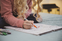 teen girl coloring in her room 