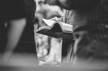 people holding Bibles during a worship service 