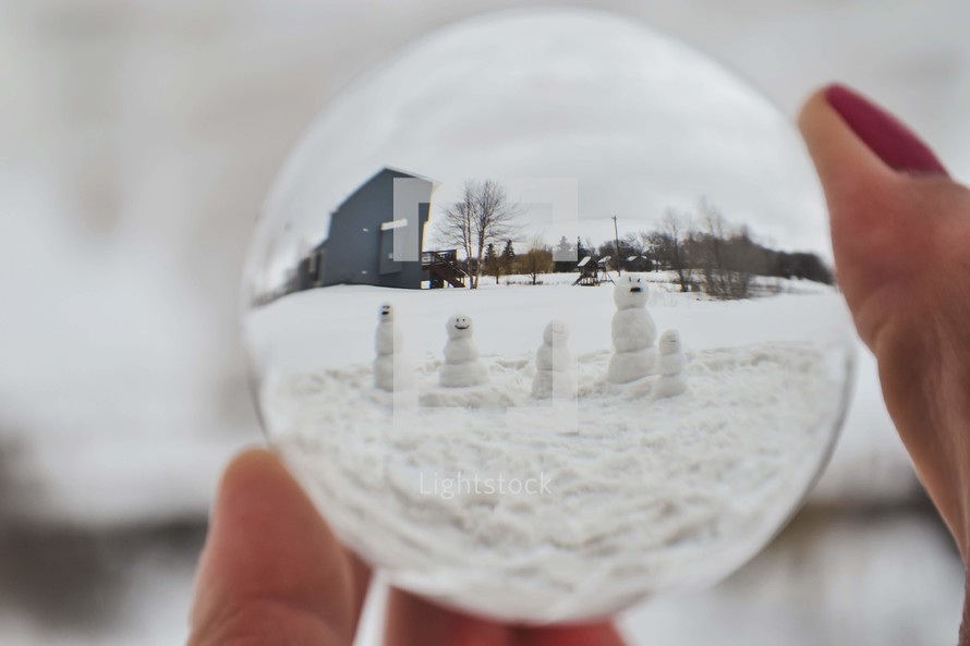 snowman family through a glass sphere 