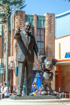 Paris, France - June 02, 2023: In Disney Studio 1 there is the bronze statue "Partners", created by Imagineer Blaine Gibson, which represents Mickey alongside Walt Disney.