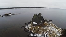 Aerial view of old house on winter coast