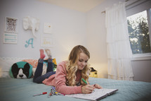 teen girl coloring in her room 