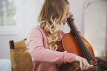 teen girl playing a cello 