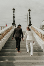 couple walking up steps outdoors 