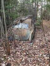 abandoned vehicle in the woods 