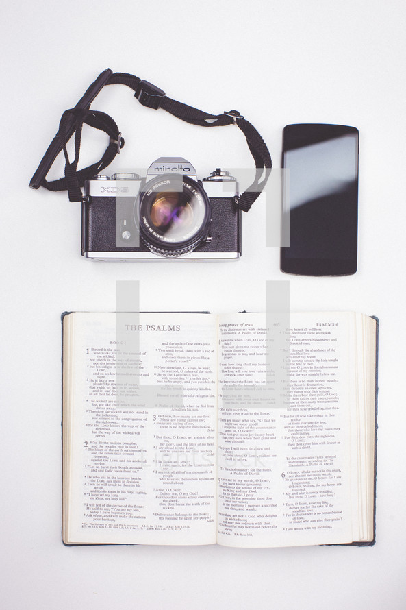 camera, cellphone, and open Bible 