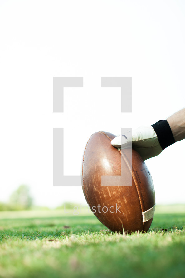 football player holding a football 