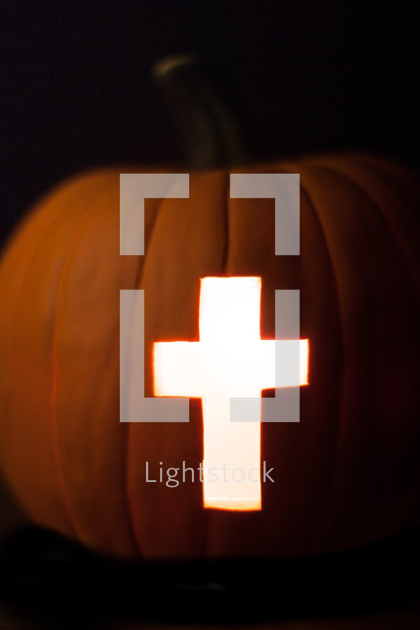 Light of the world pumpkin with cross of Jesus - cross carved in a Jack-O-Lantern pumpkin 