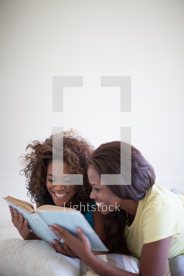 mother and daughter reading a Bible together
