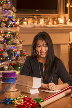 a woman addressing Christmas cards 