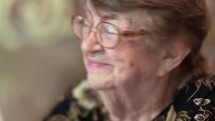 Indoor portrait of happy elderly woman