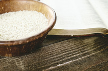 wood bowl of rice and Bible 