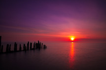 old pier pilings at sunset