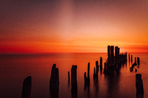 old pier pilings at sunset