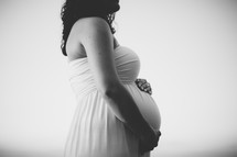 pregnant woman with her hands on her belly 