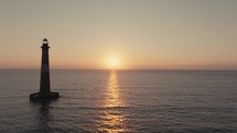 A lighthouse on the  Atlantic Ocean coast of South Carolina during sunrise 