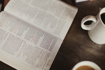 opened Bible and coffee cup