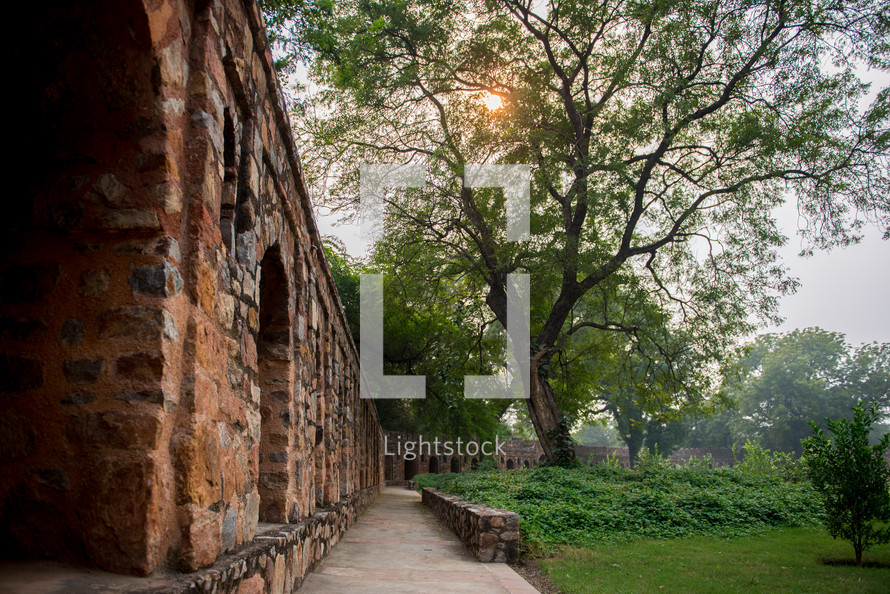 brick wall, walkway, and garden in Delhi, India 