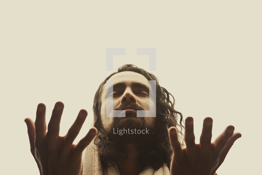 Close up of Jesus lifting his hands in prayer isolated on white