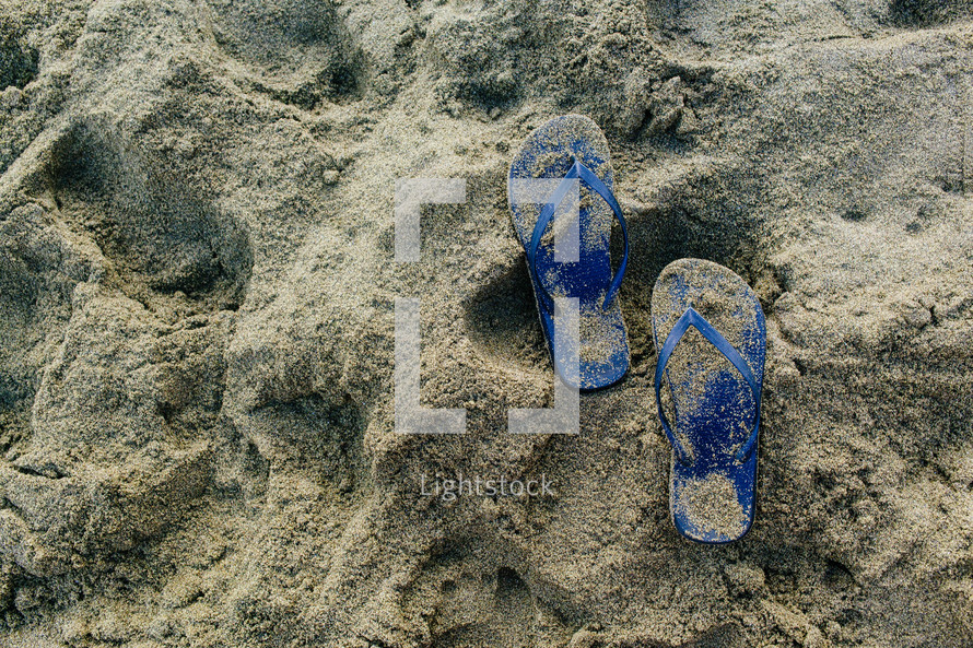 flip flops in the sand on a beach 
