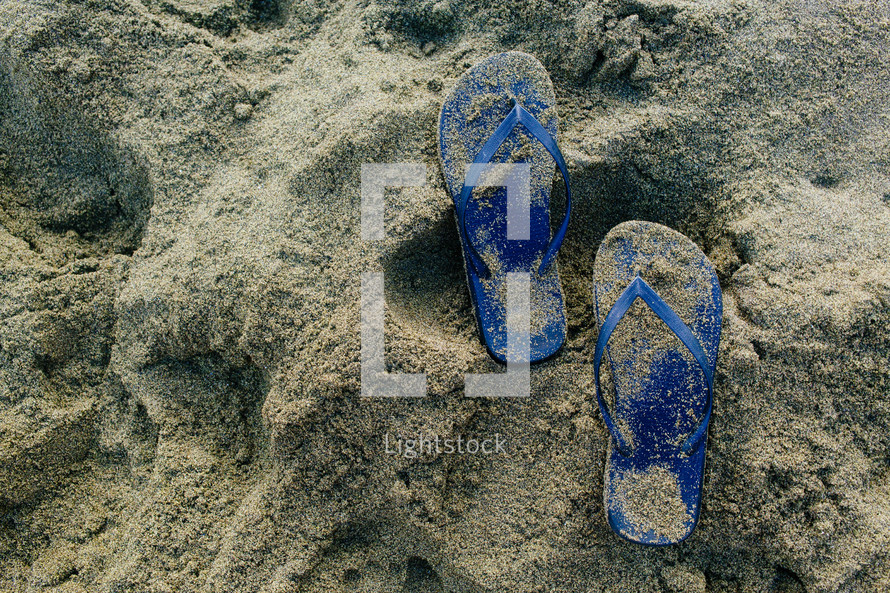 flip flops in the sand 