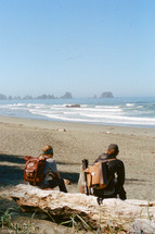 backpackers resting on a beach 