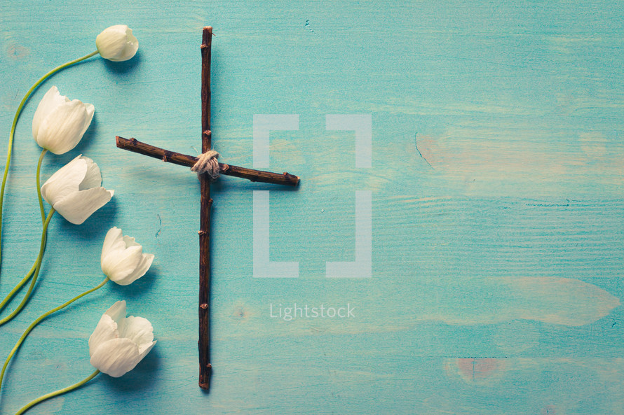 anemone flowers and cross made of sticks 