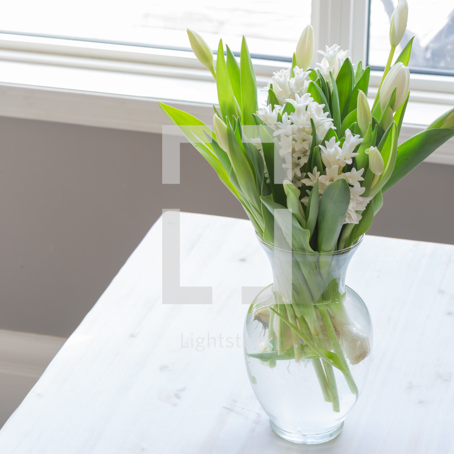 White hyacinth and tulips in a vase 