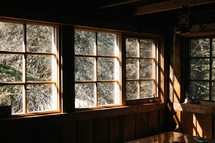 Sunlight coming through windows in wood cabin