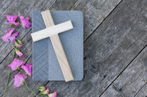 pink flowers, Cross on book and rustic wood
