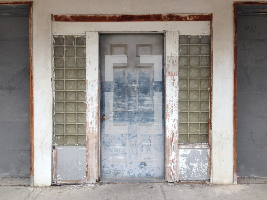 entry area with a weathered wooden door