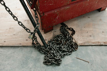 Chain by a wood box.