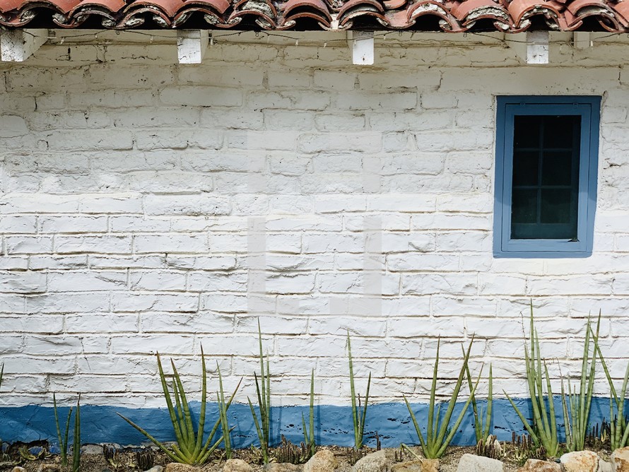 white brick wall with blue trim 