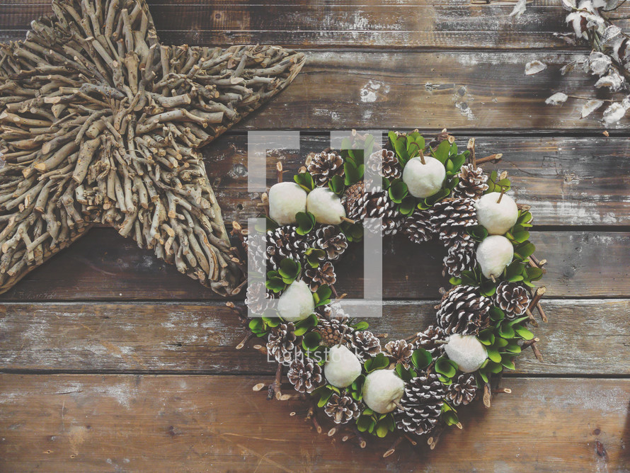 Christmas pine wreath and star in farmhouse barn wood