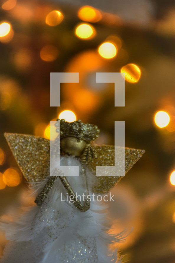 Christmas angel against bokeh Christmas lights 