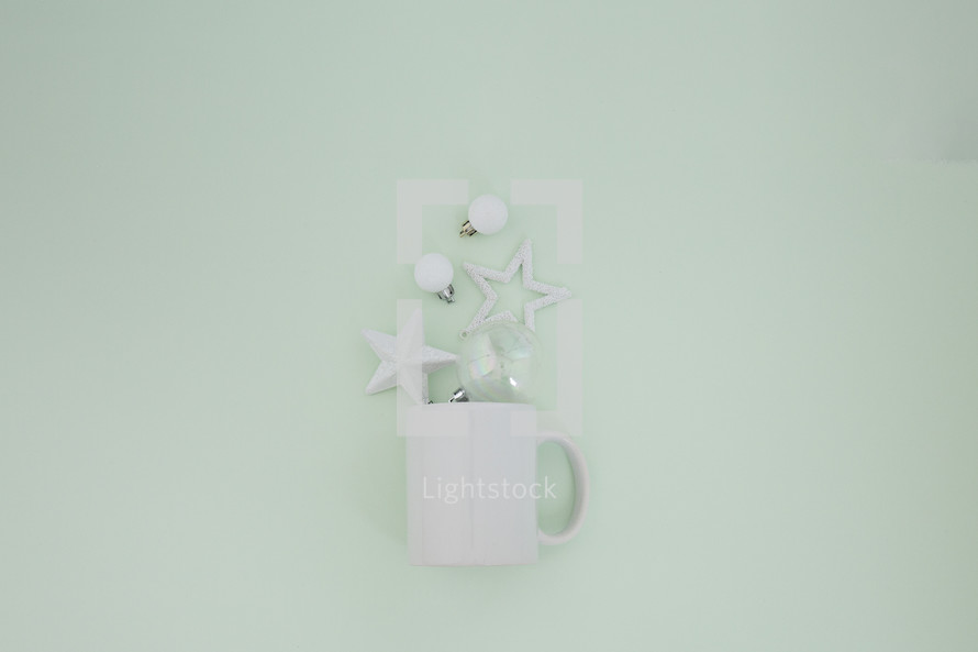 mug with white ornaments on mint green 