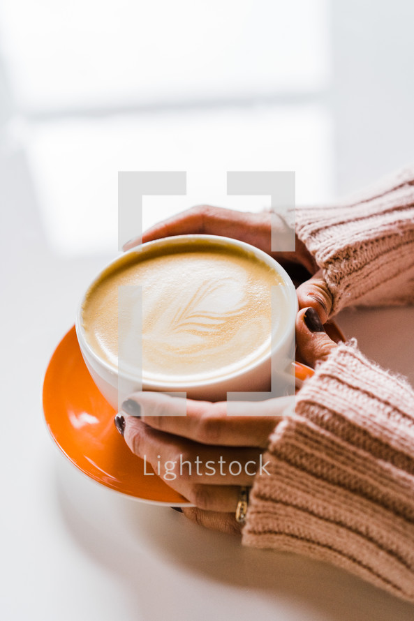hands on a cup of coffee 