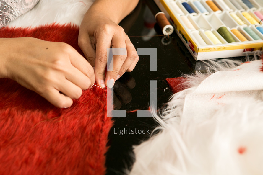 seamstress sewing a fox costume 