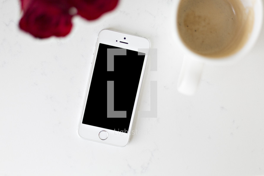 iPhone on a white background with coffee mug 