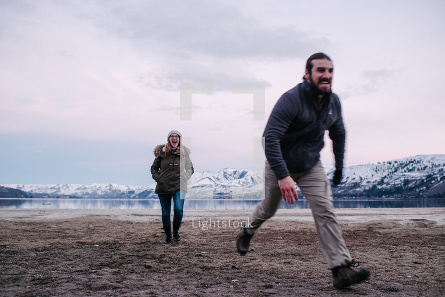 a couple running by a lake shore in Washington