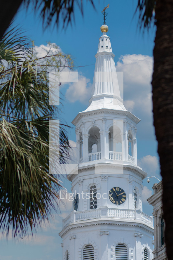 Church steeple with palm trees