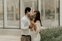  bride and groom kissing outdoors 