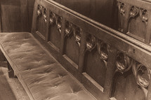 Church Pew with Velvet Cushion and Wooden Carvings in Sepia