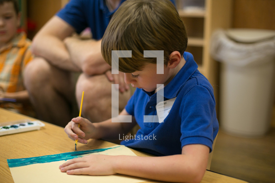 A boy using watercolors during children's church