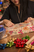 a woman wrapping Christmas gifts 