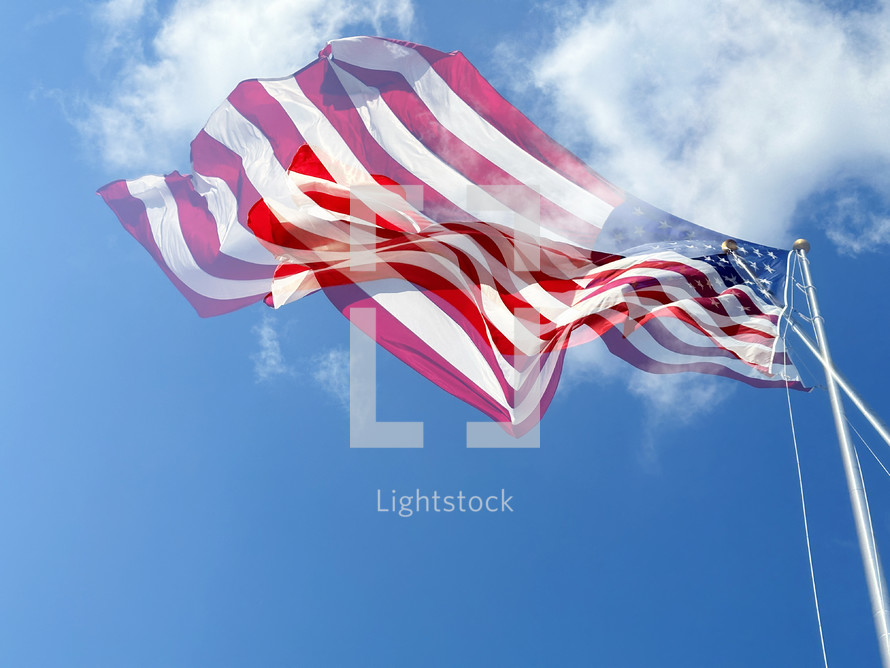 Two American flags layered over each other