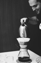 a man slow brewing coffee 