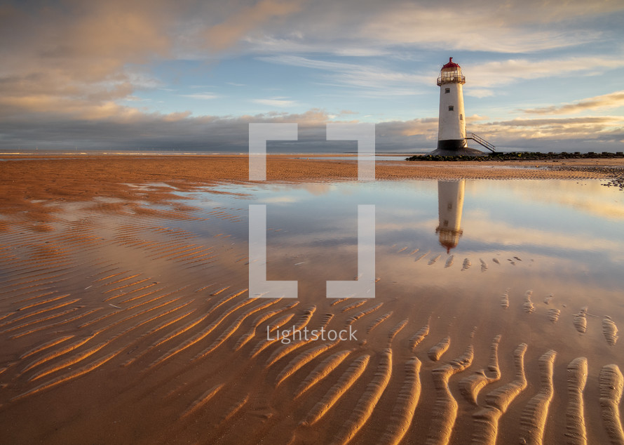 lighthouse and ripples in sand 